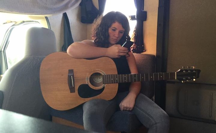 Girl Playing Guitar and Holding Phone