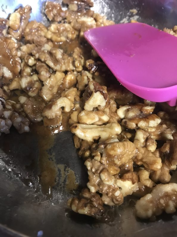 caramelized candied walnuts in a frying pan 