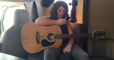 Girl Playing Guitar and Holding Phone