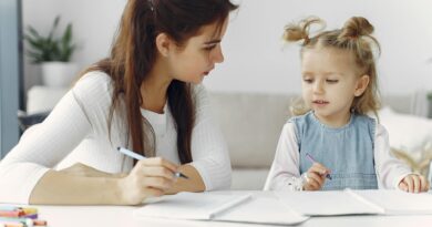 woman teaching little kid how to draw